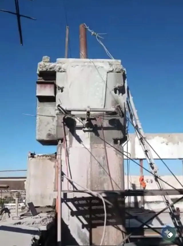 Diamond wire cutting a concrete column in the open