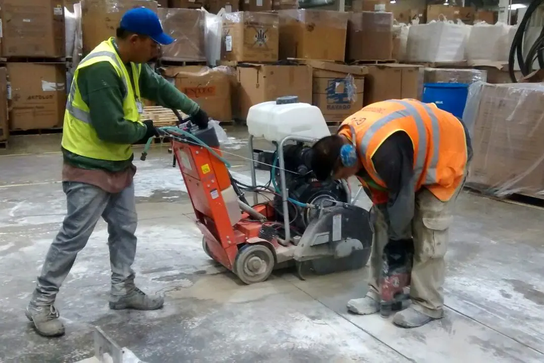Concrete barrier cutting on a roadway with a diamond blade saw